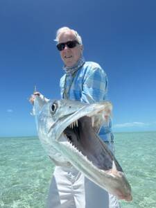 Angler holding a large barracuda caught near Mars Bay, South Andros, Bahamas