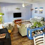 South Villa living room at Mars Bay Bonefish Lodge with cozy seating and panoramic Caribbean Sea views.