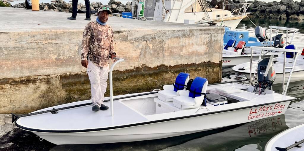 Guide Pap standing on one of the new Mars Bay skiffs at the dock, ready for a day on the flats.